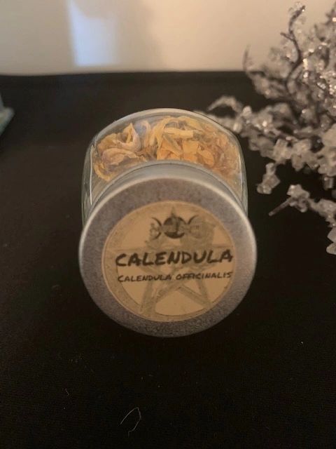 Calendula flowers in small herb bottle