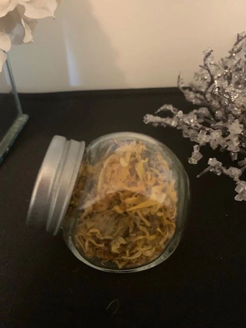 Calendula flowers in small herb bottle